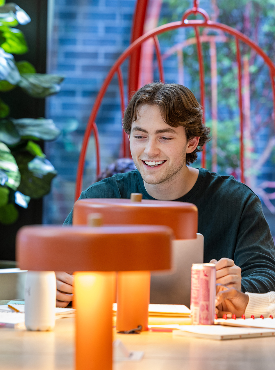 A man smiling at a table